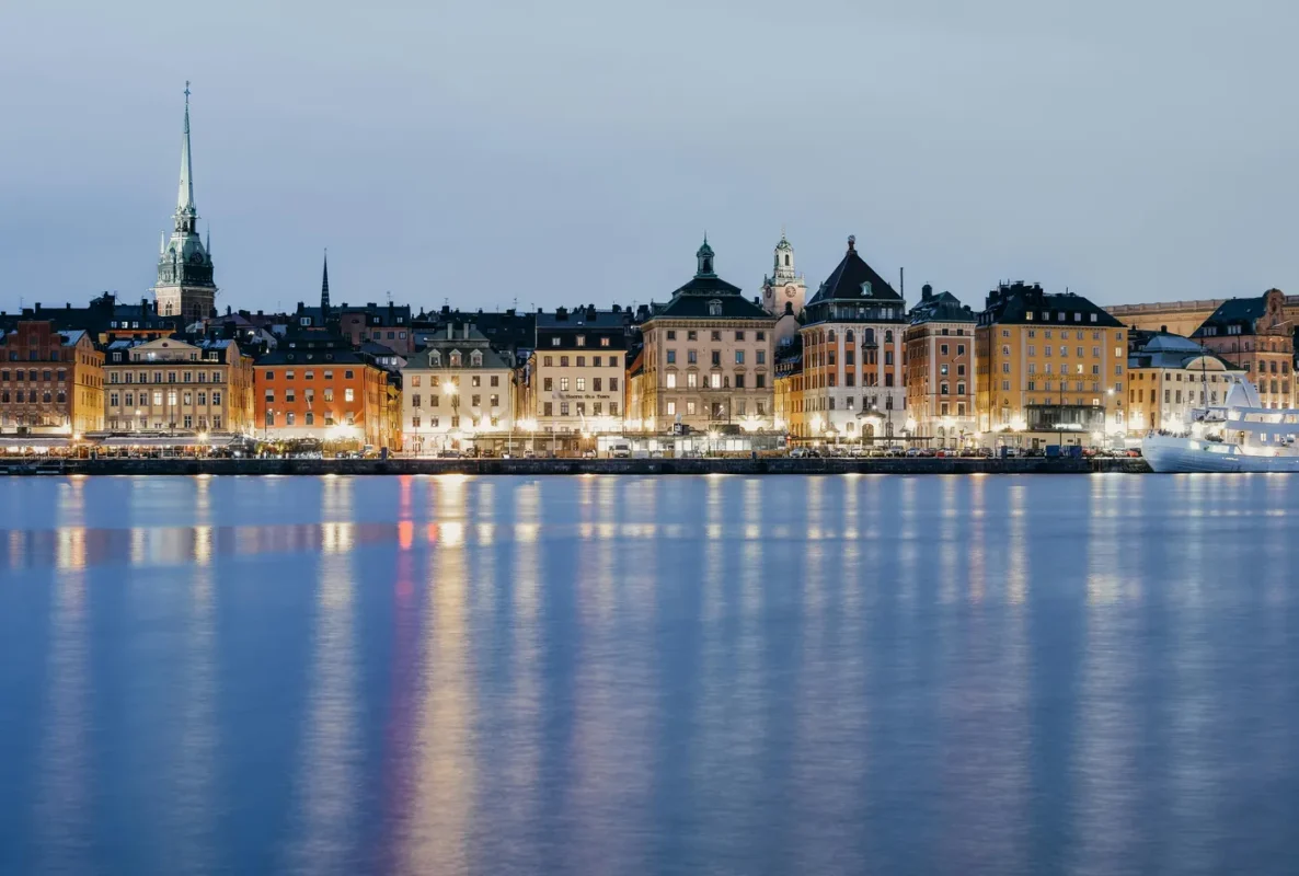 Best eSIM for Sweden: Stockholm waterfront at twilight with historic buildings reflected in calm waters