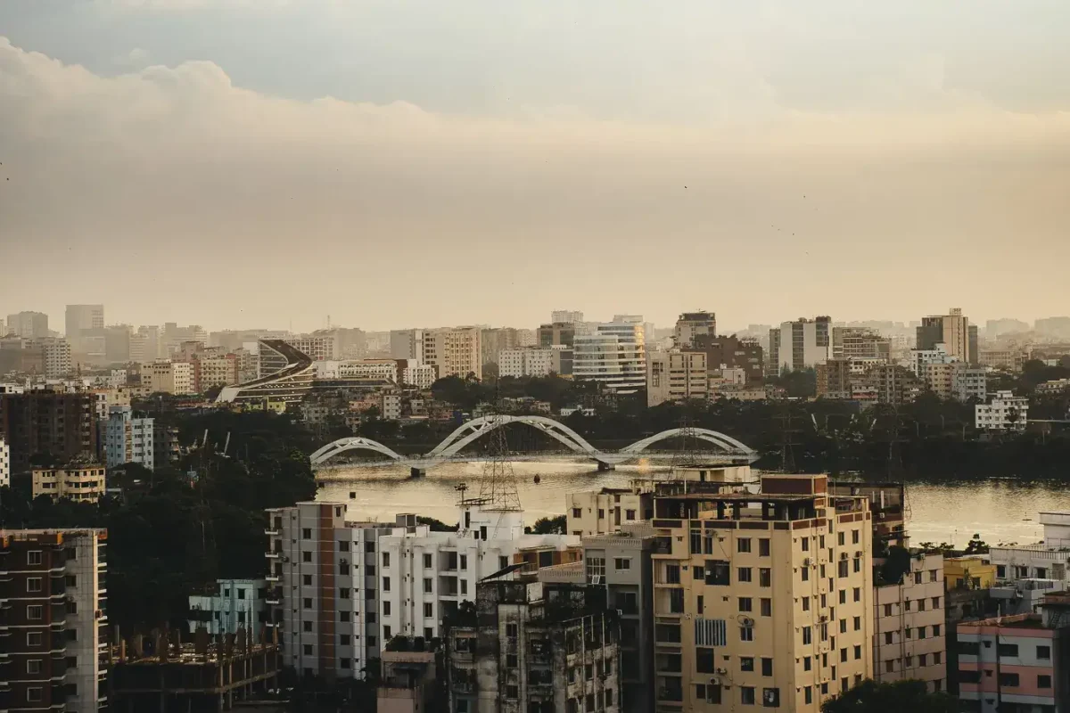 Best eSIM for Bangladesh: aerial view of the Dhaka city skyline at sunset with a bridge over the river.