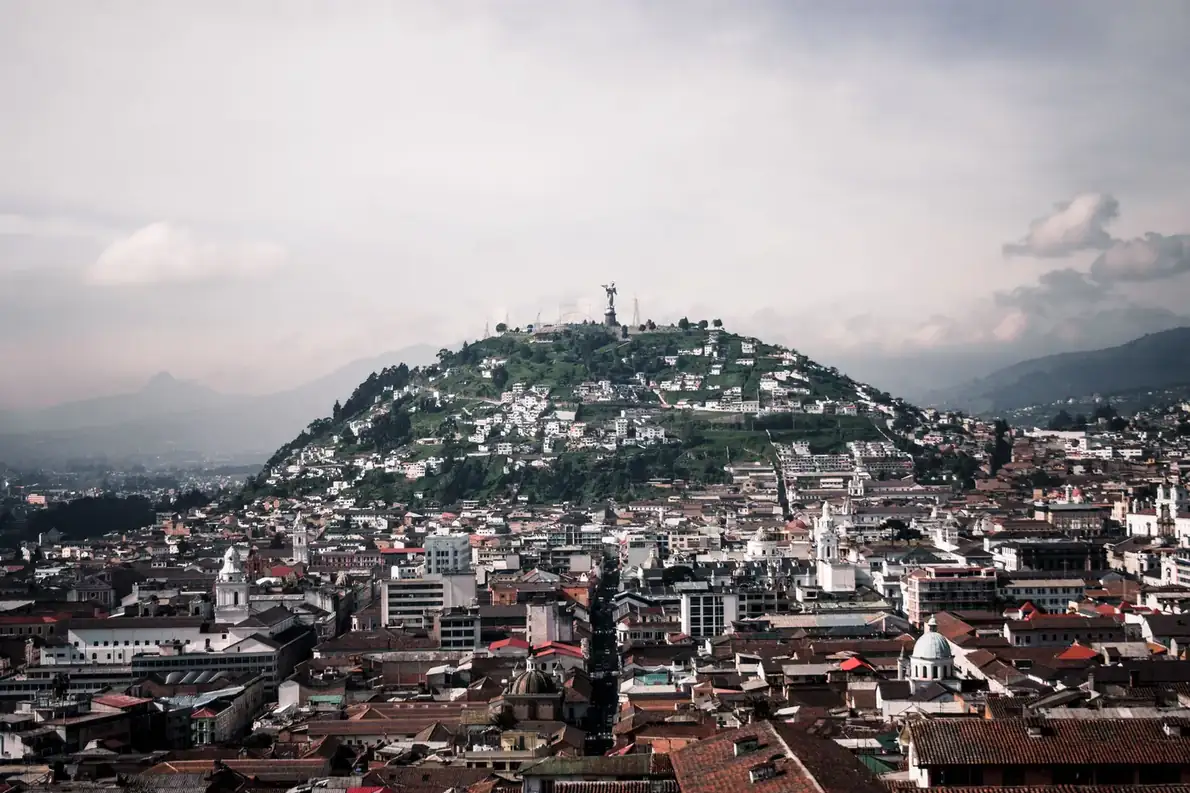 Best eSIM for Ecuador: aerial view of Quito with El Panecillo hill and the Virgin of Quito statue