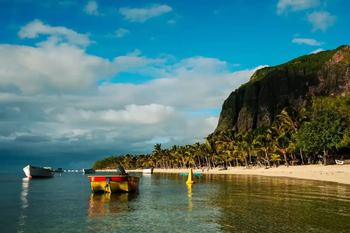 Best eSIM for Mauritius: boats and palm trees on the coast at Le Morne Brabant